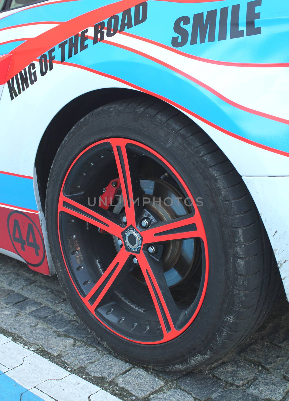 Close up of a car wheel with red brake