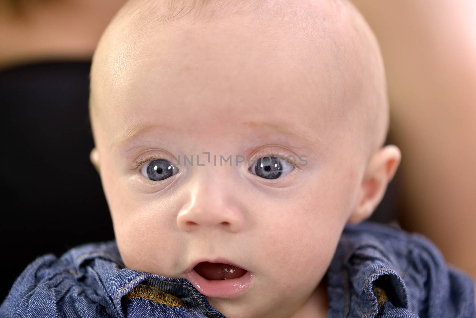 Close-up of a baby girl with beautiful blue eyes 
