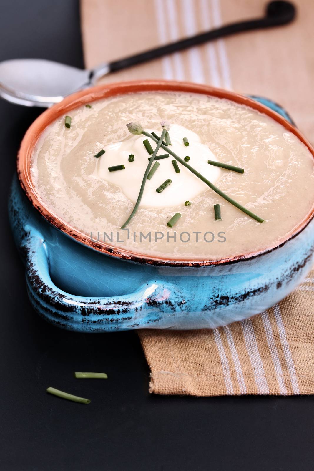 Potato and Leek Soup with sour cream and chives. Extreme shallow depth of field.