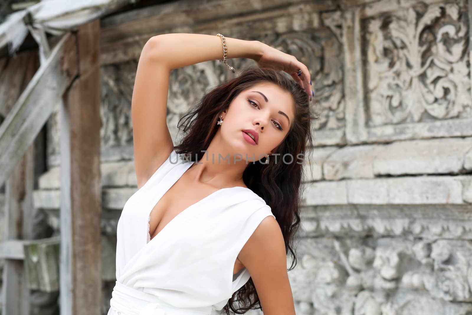 Portrait close up of young beautiful woman in white dress