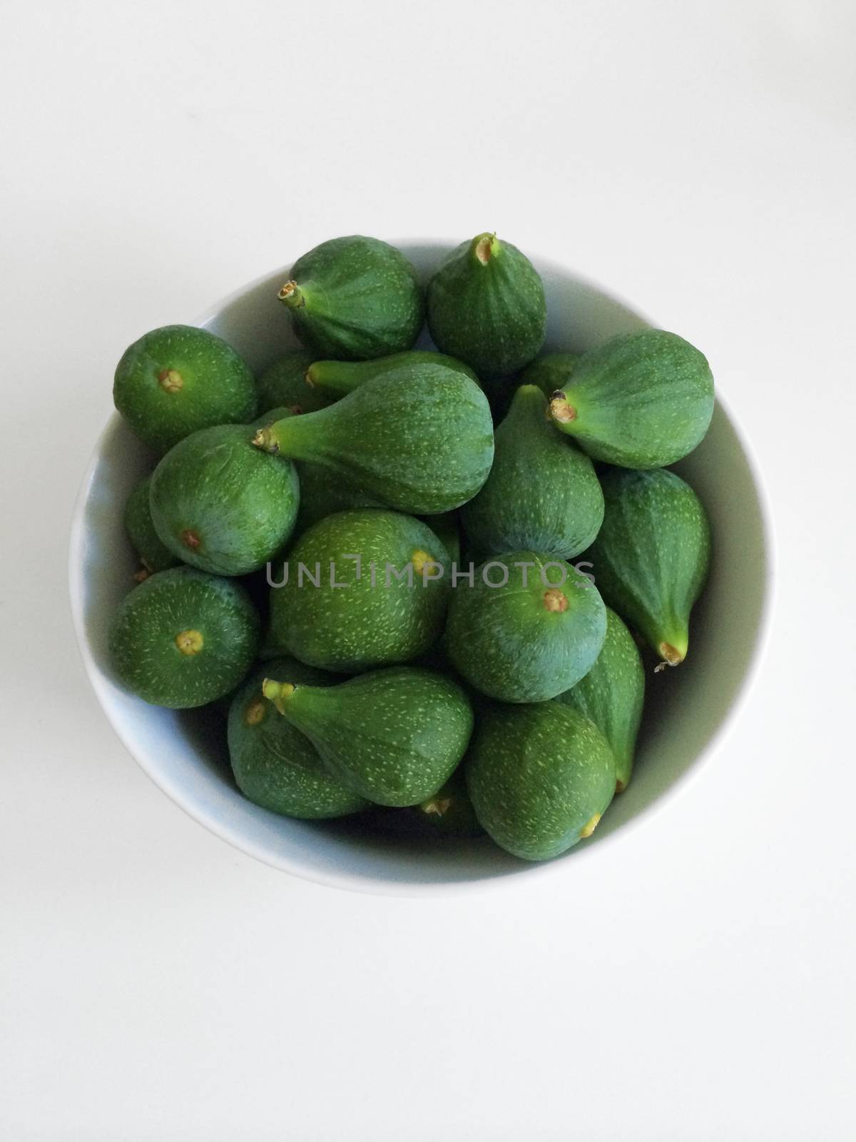 White bowl of green figs