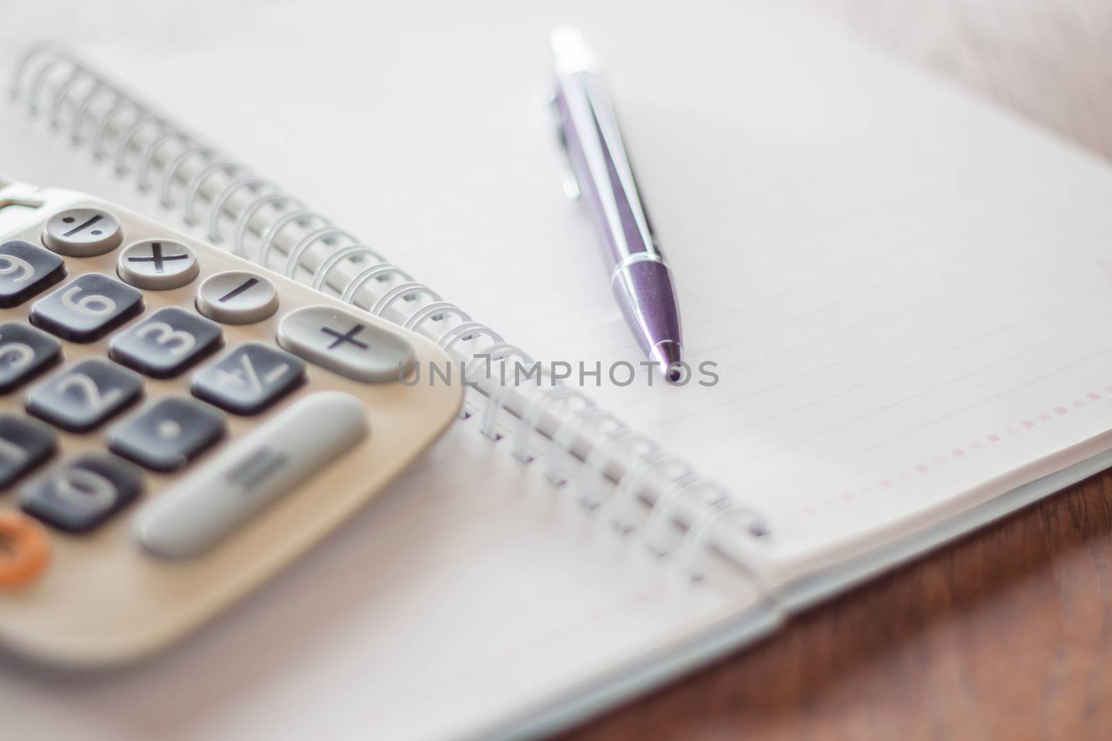 Business concept with calculator, pen and notebook by punsayaporn