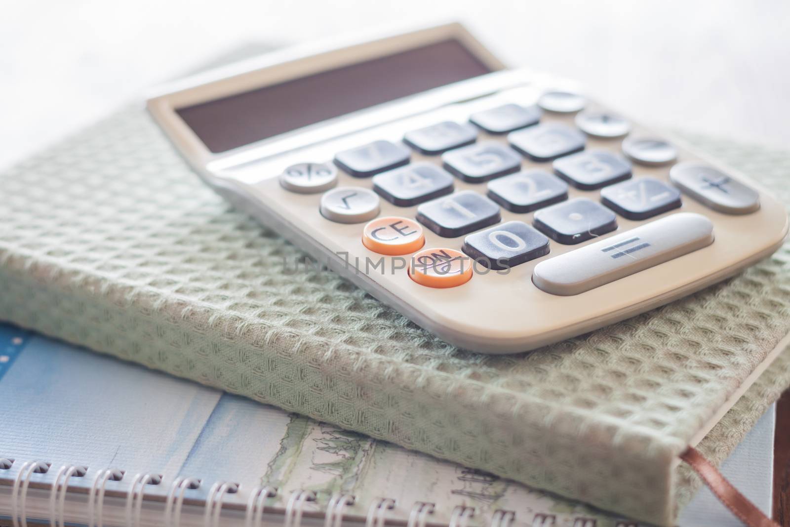 Calculator on two of notebooks, stock photo