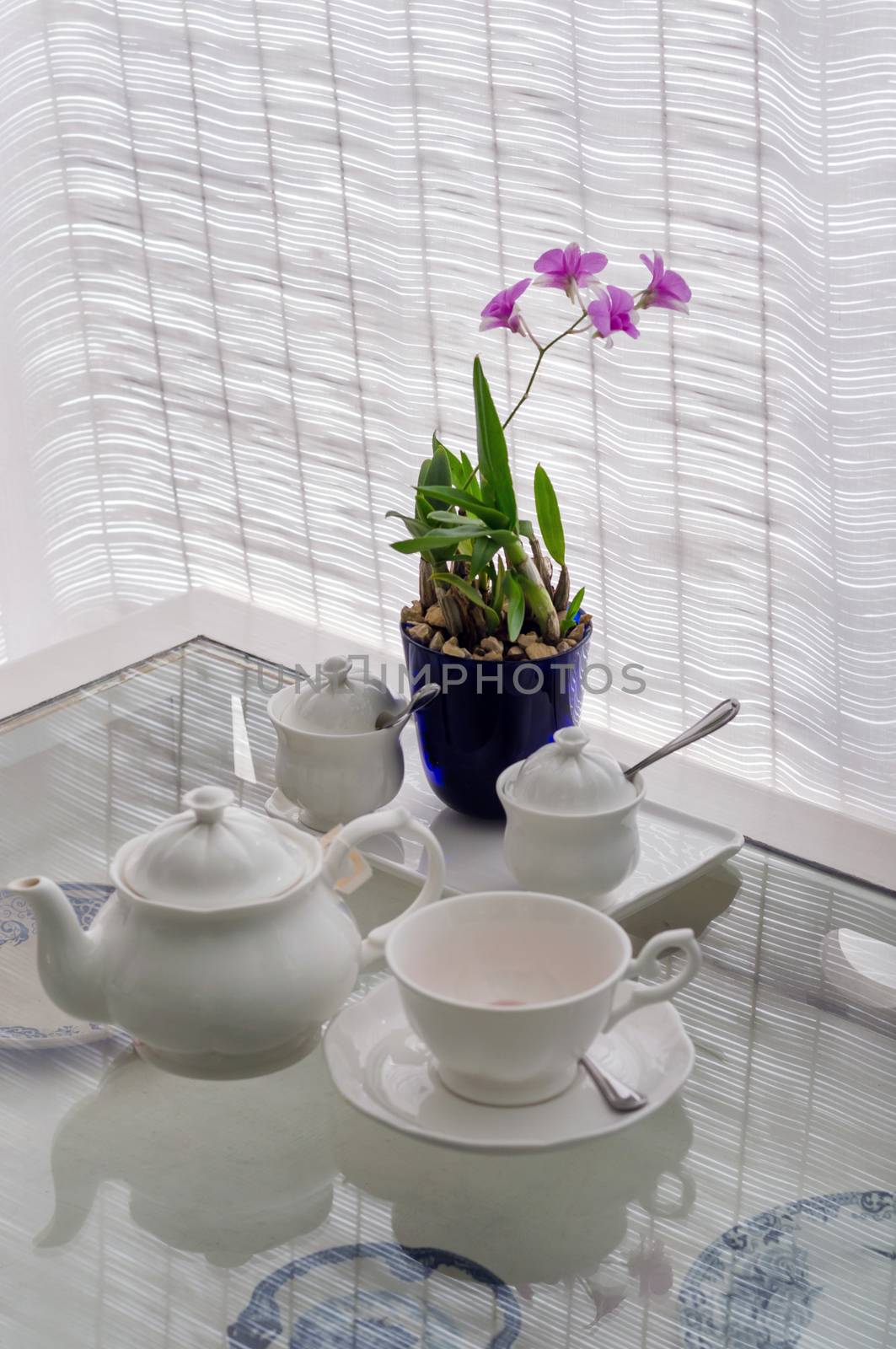 Ceramic utensils on table with flower decoration