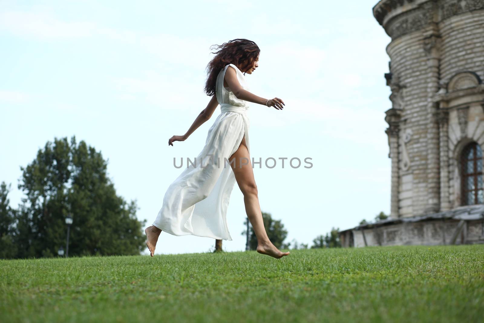 Sexy woman in a white dress on a background of the church