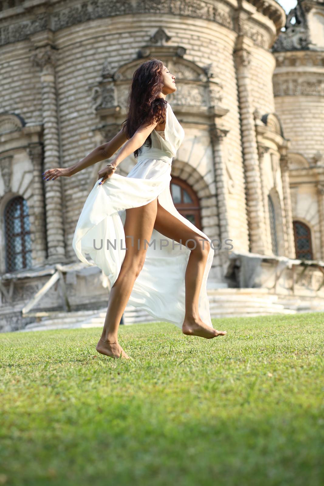 Young woman in a white long dress by andersonrise