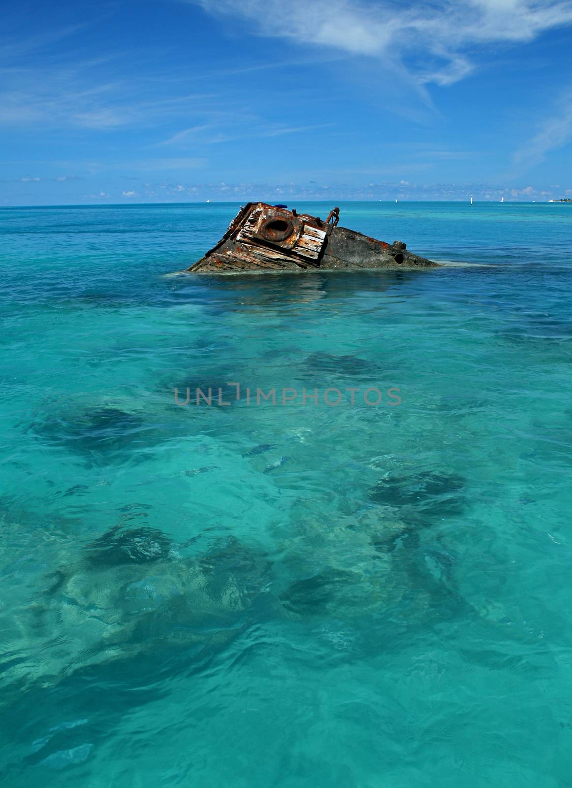 One end of a ship wreck (the Vixen) emerging from a tropical Sea