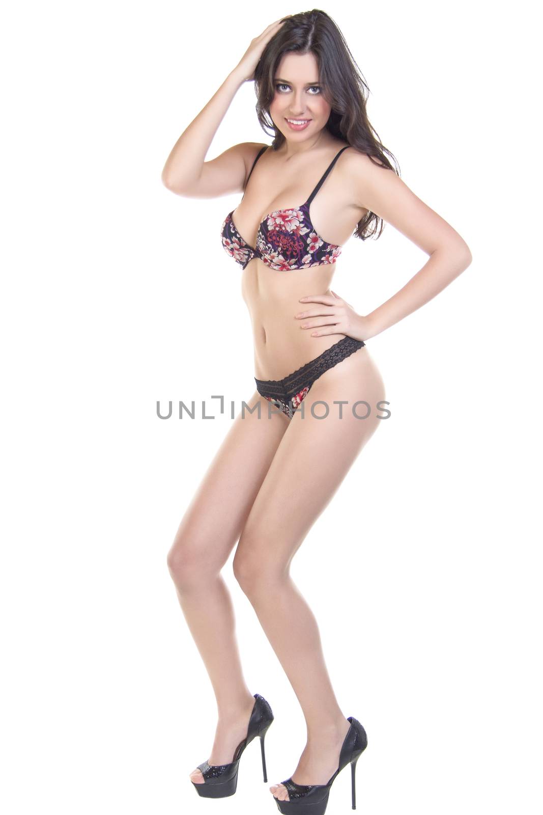 Sexy brunette woman posing in lingerie on isolated white