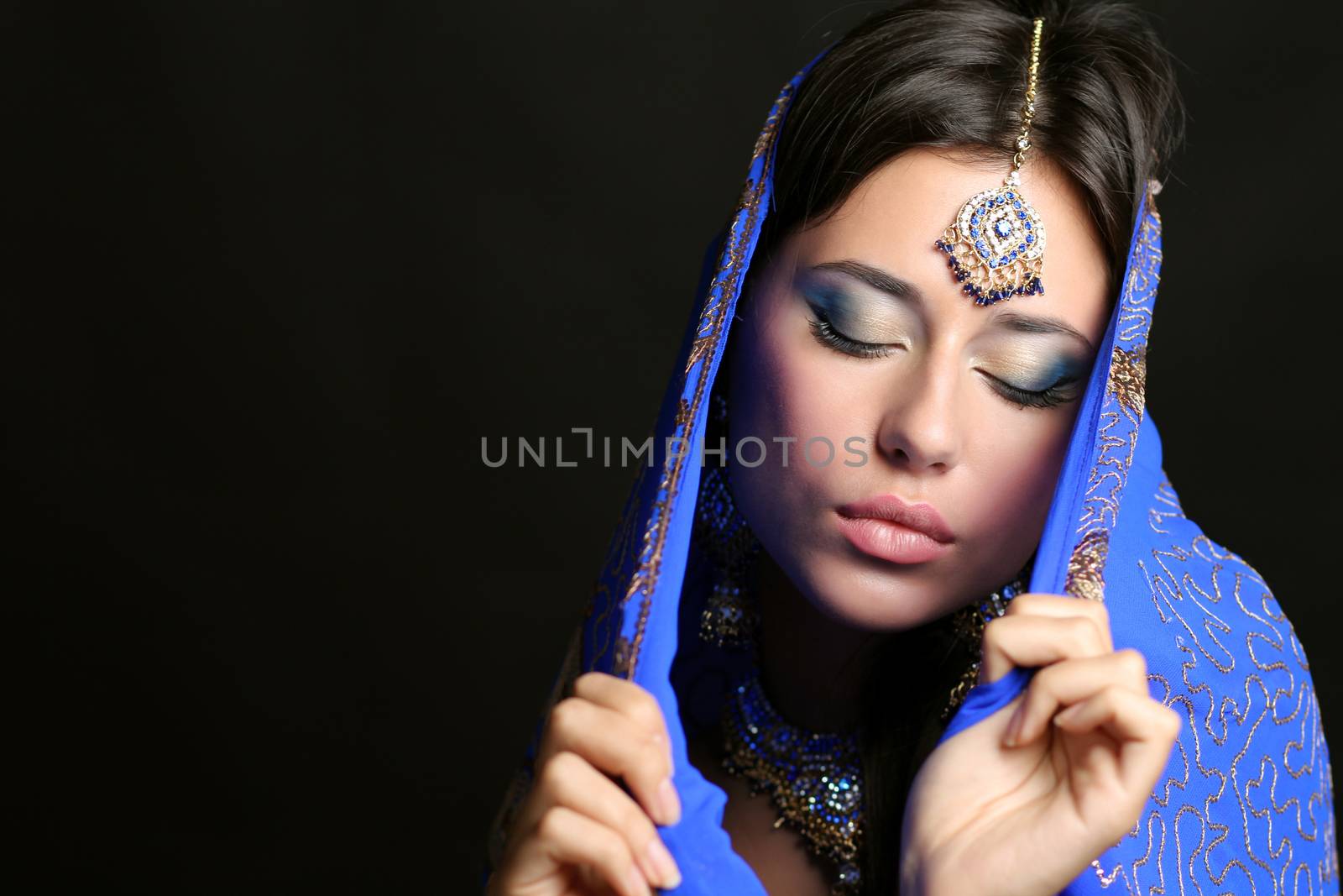 Young beautiful brunette woman in indian blue dress