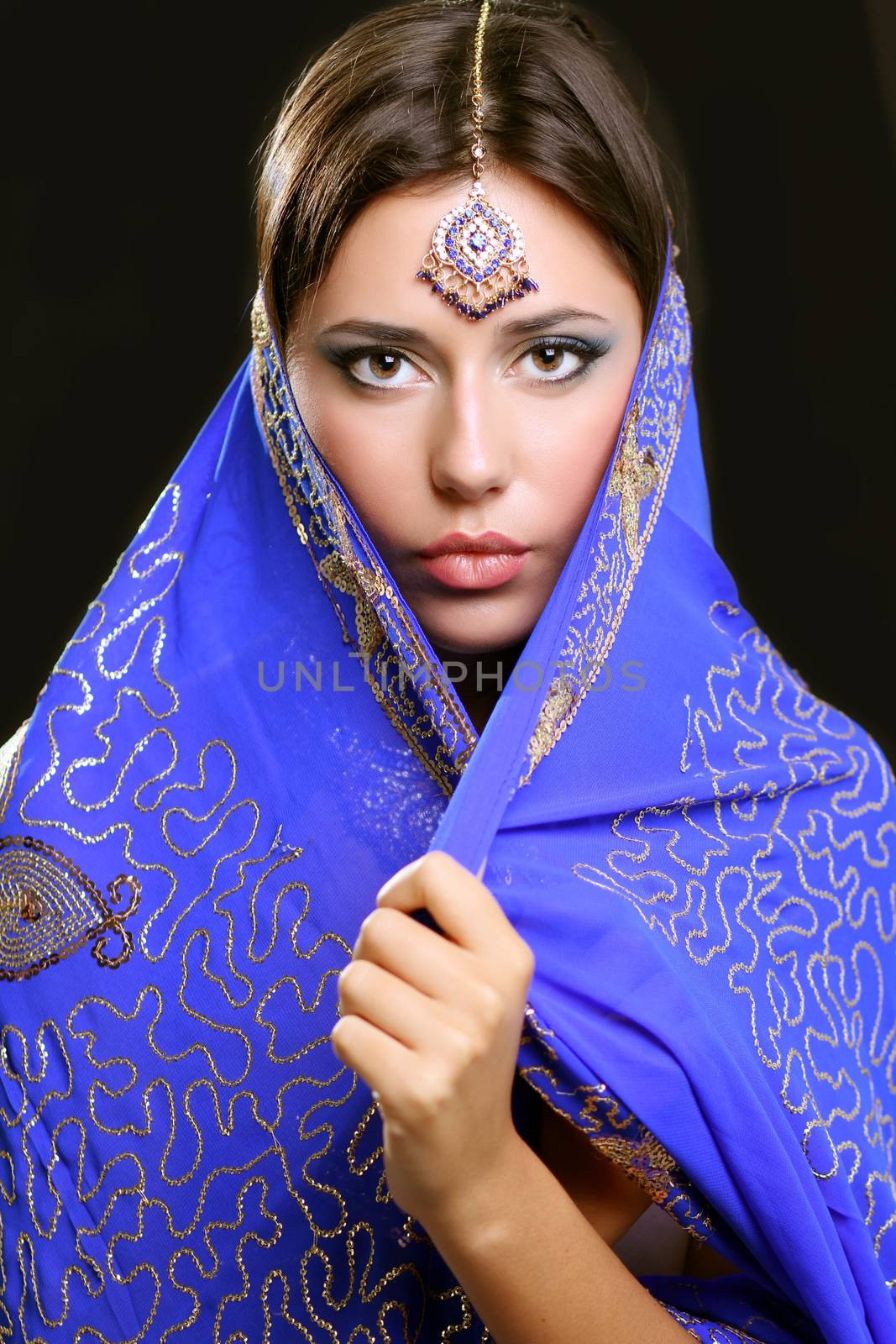 Young beautiful brunette woman in indian blue dress