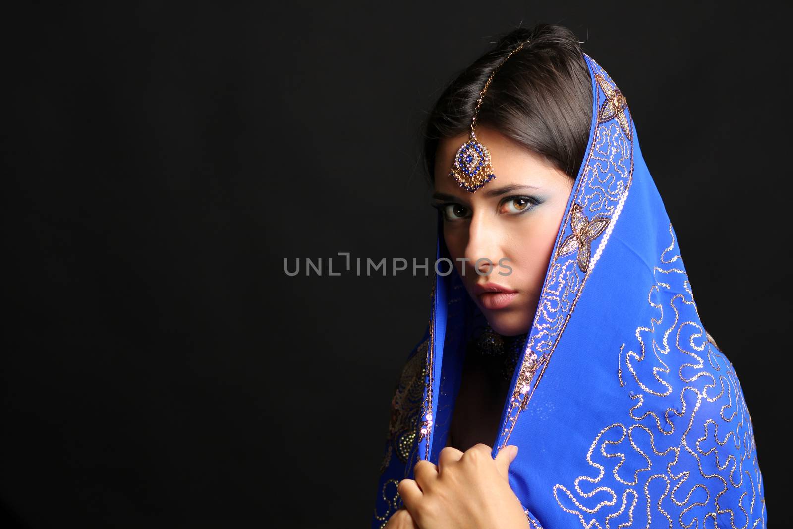 Young beautiful brunette woman in indian blue dress