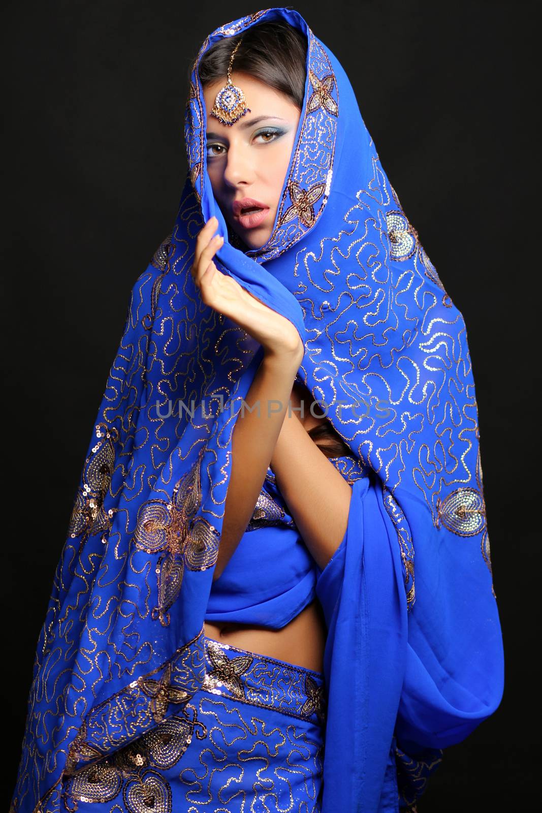 Young pretty woman in indian blue dress by andersonrise