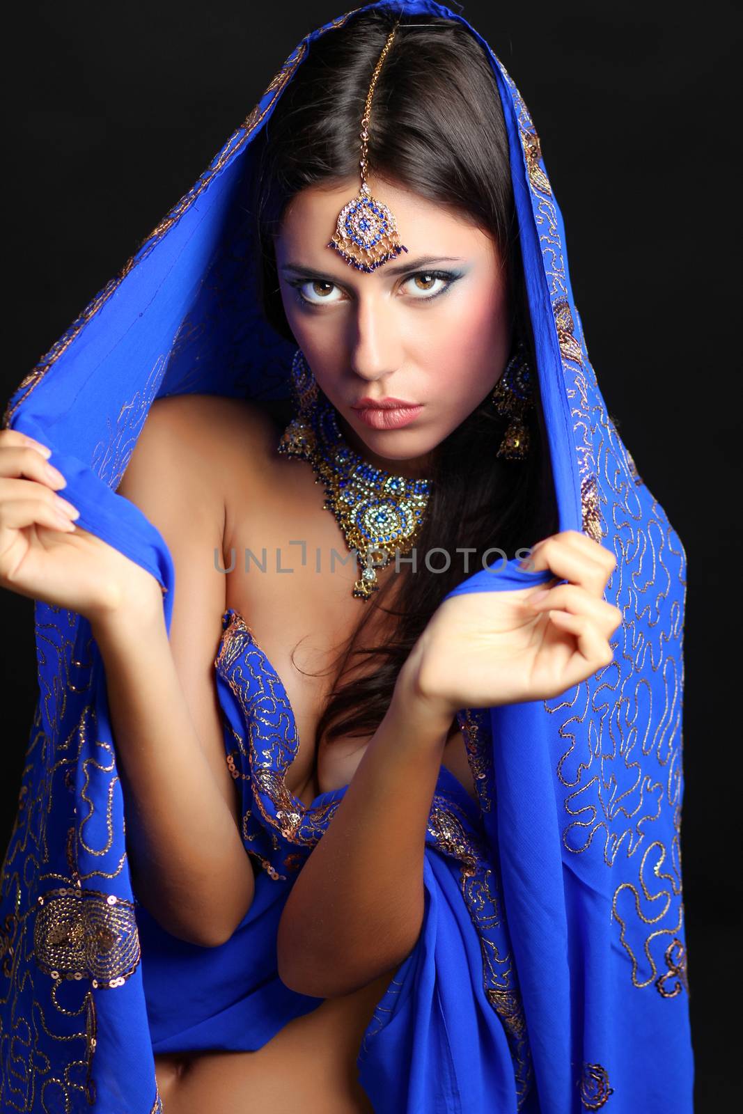 Young beautiful brunette woman in indian blue dress