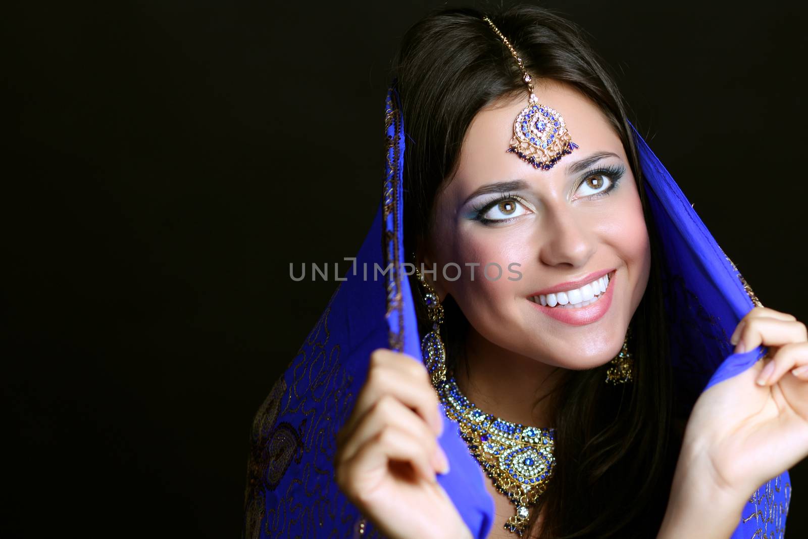 Young beautiful brunette woman in indian blue dress