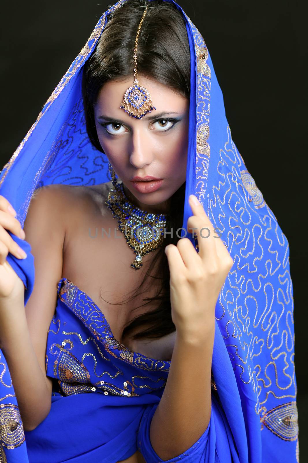 Young beautiful brunette woman in indian blue dress