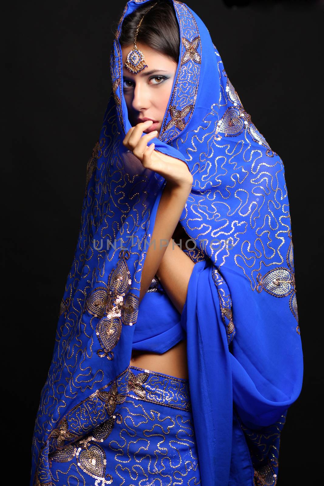 Young pretty woman in indian blue dress by andersonrise