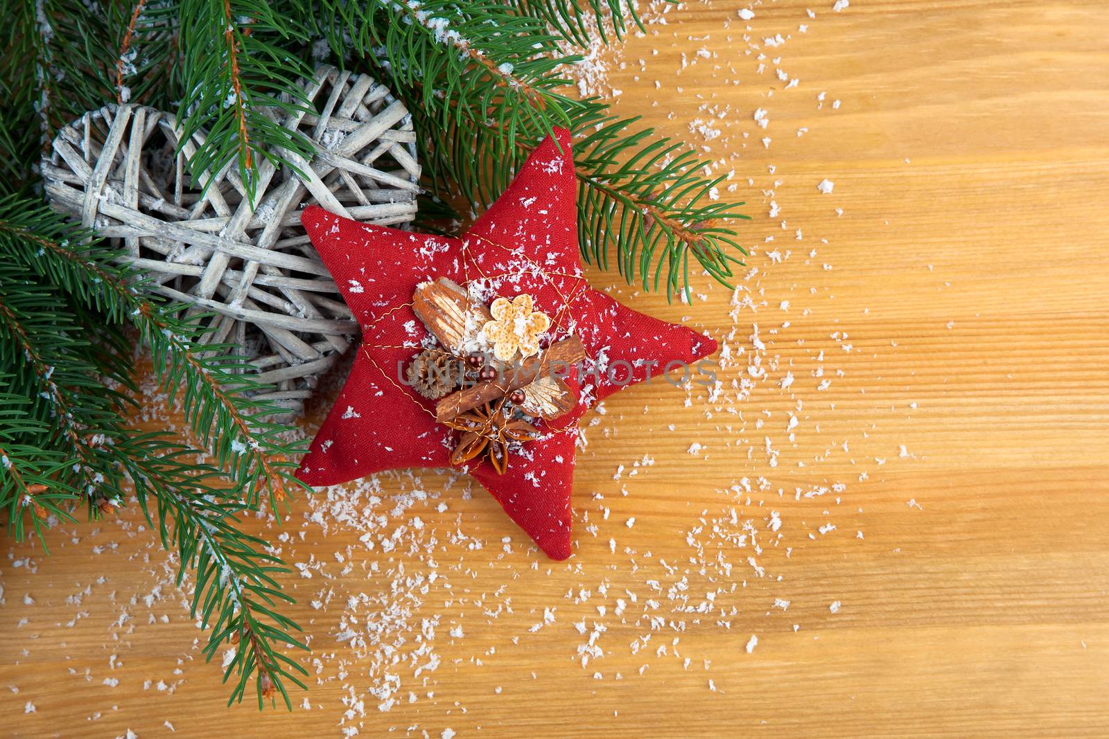 stitched red Christmas star with spices, with decoration, on wood background,