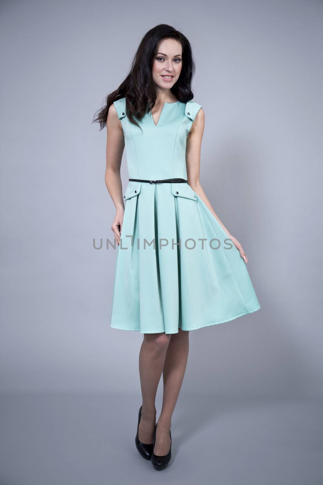 Beautiful young woman in a turquoise dress by andersonrise
