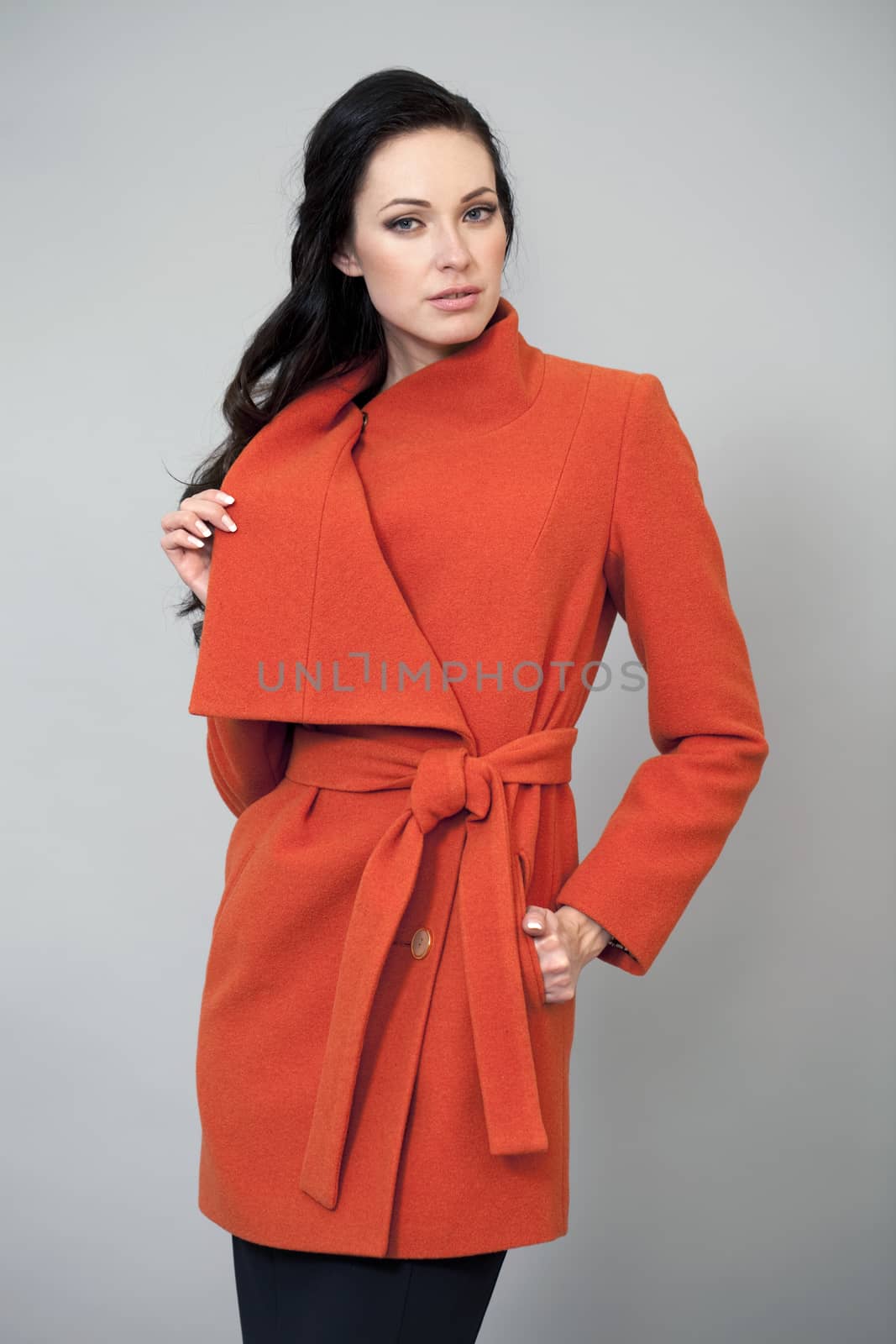 Young woman in a bright orange coat by andersonrise