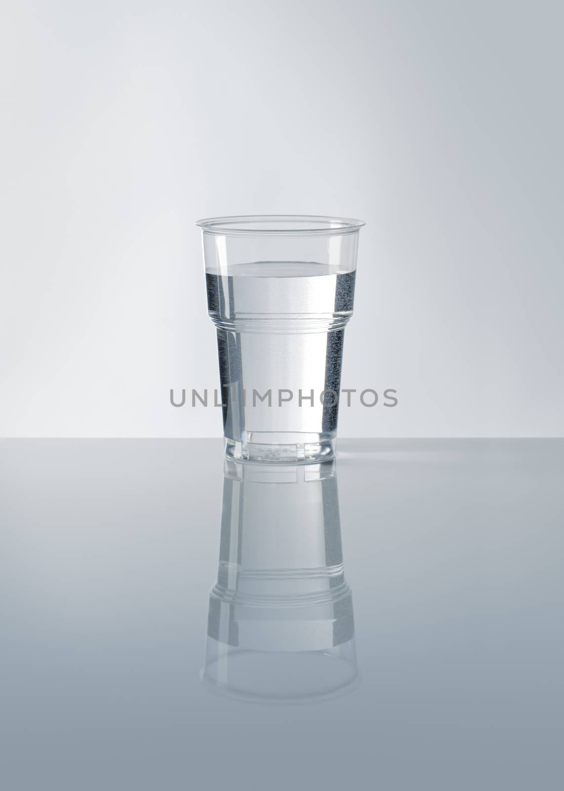 A Disposable plastic cup filled with water.