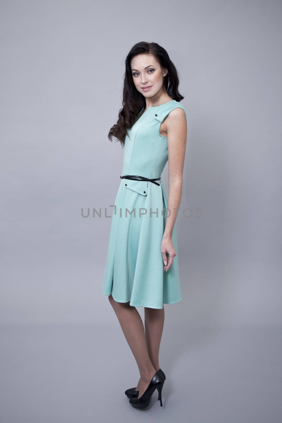Beautiful young woman in a turquoise dress by andersonrise