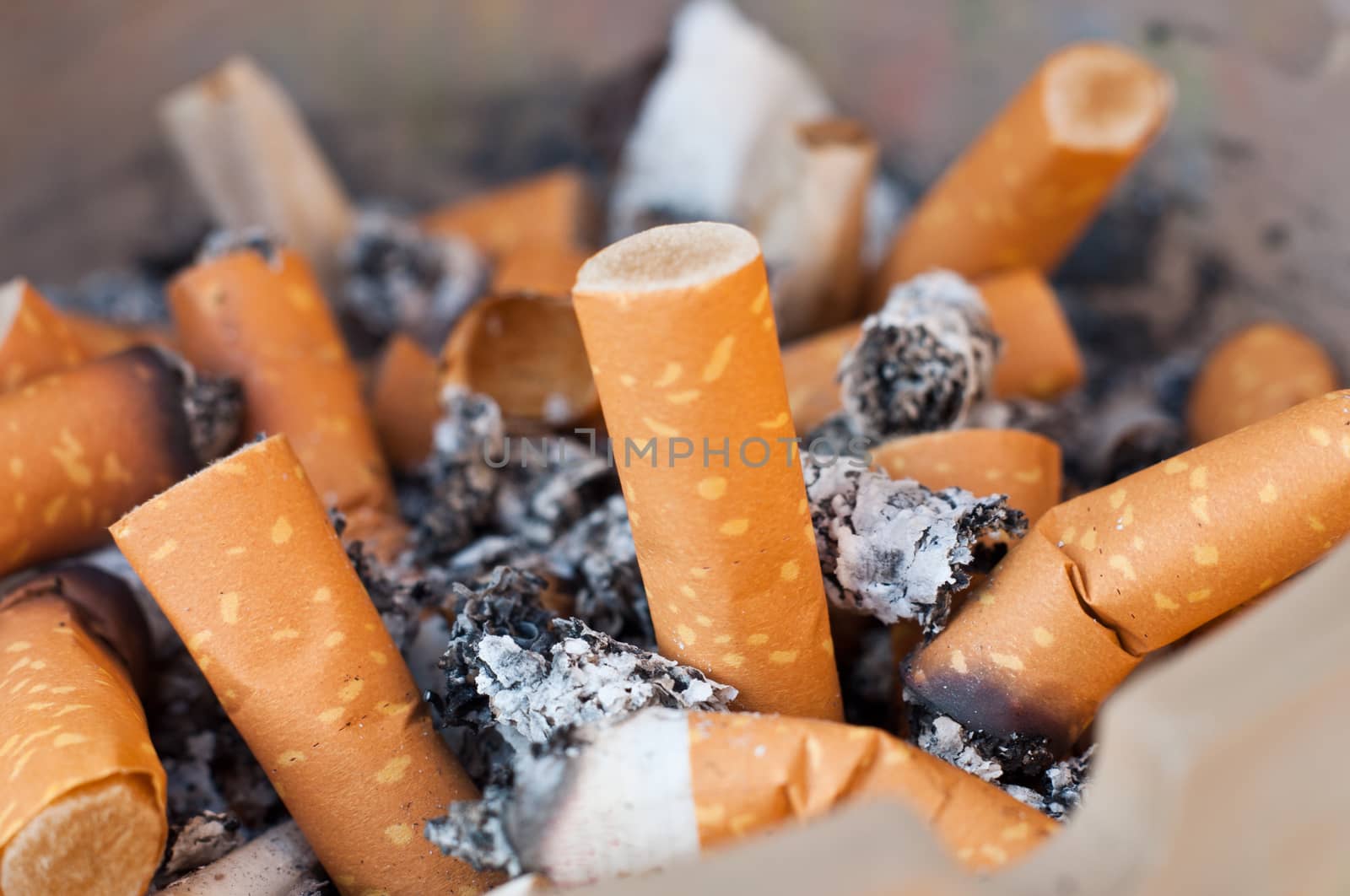 Bult of cigarettes closeup background by NeydtStock