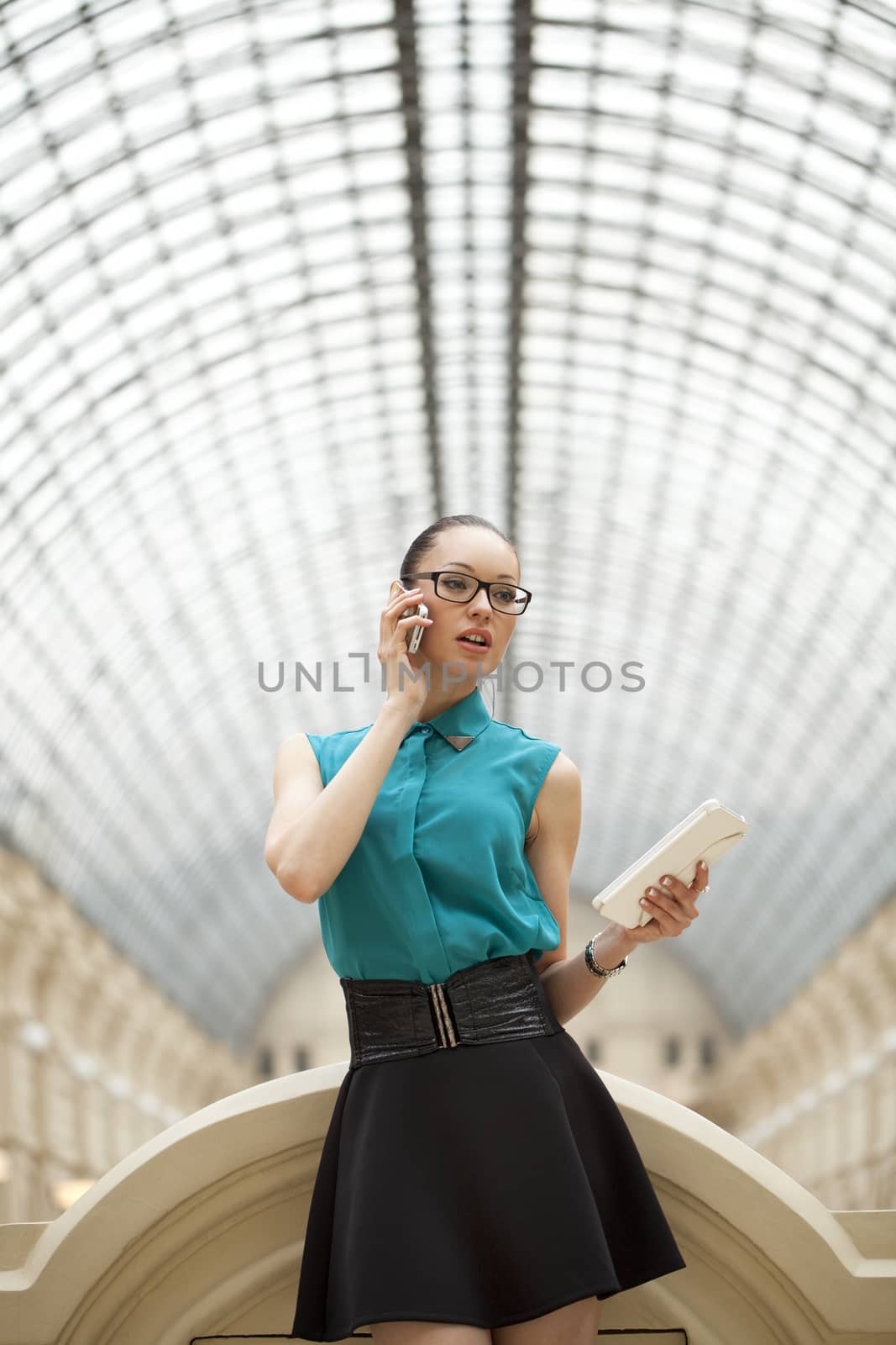 Business woman talking on cell phone by andersonrise