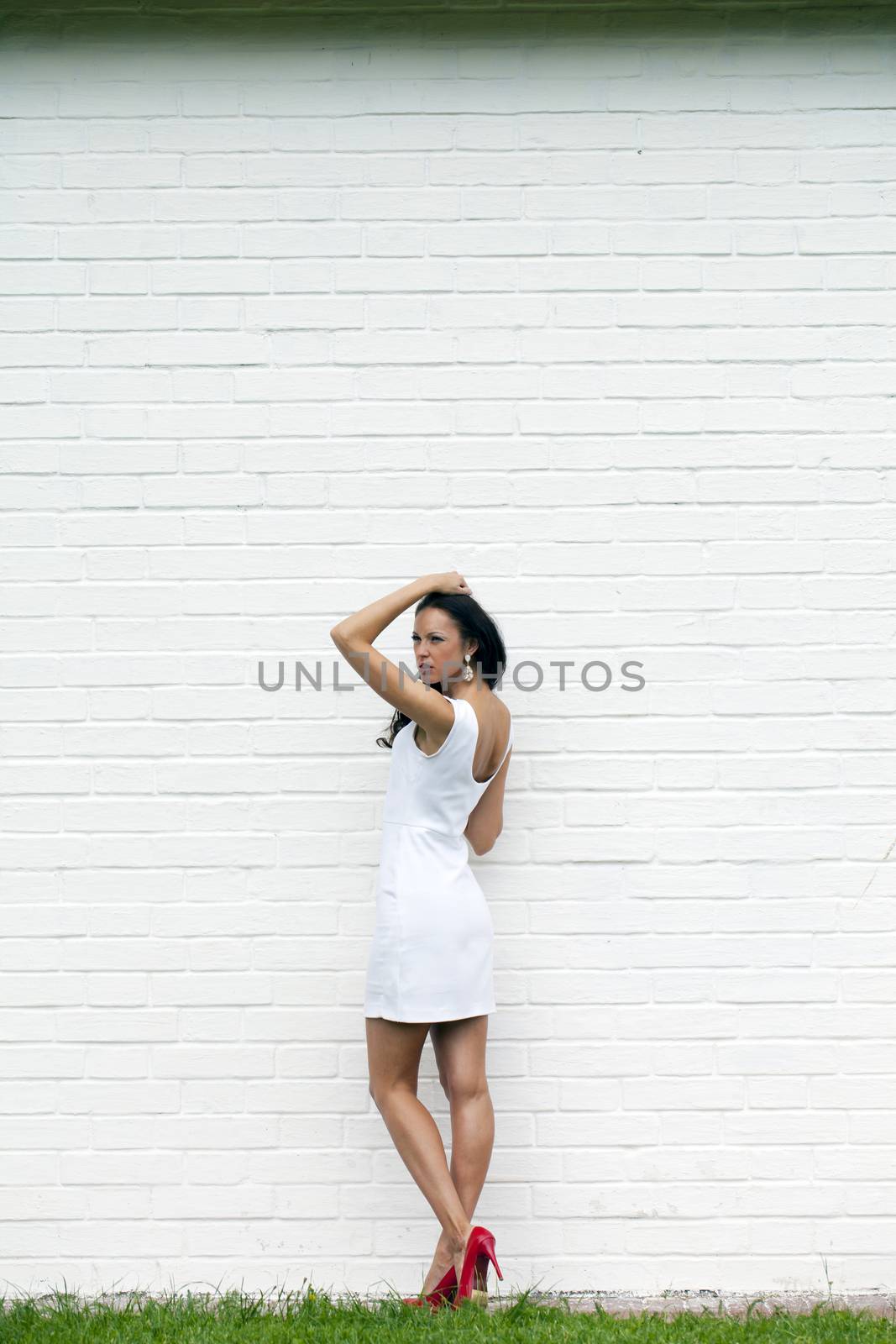 Portrait of young woman in sexy white dress