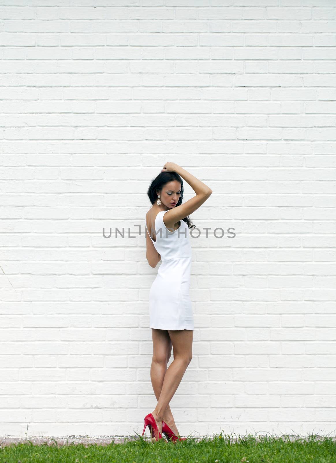 Portrait of young woman in sexy white dress