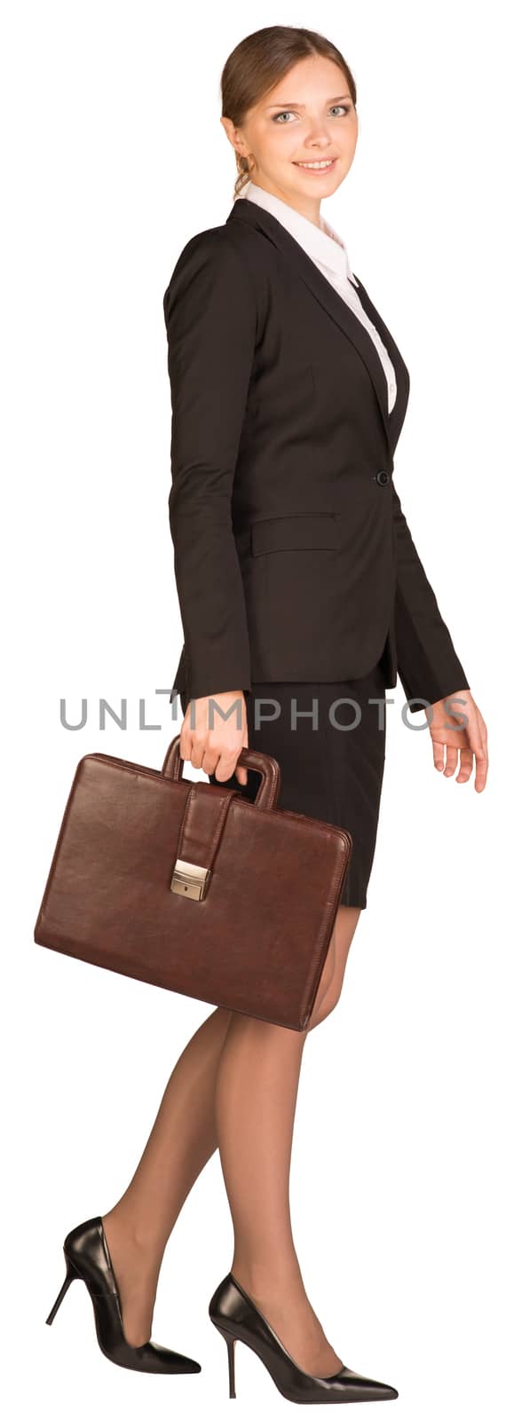 Businesswoman walks holding briefcase in his hand. Isolated on white background