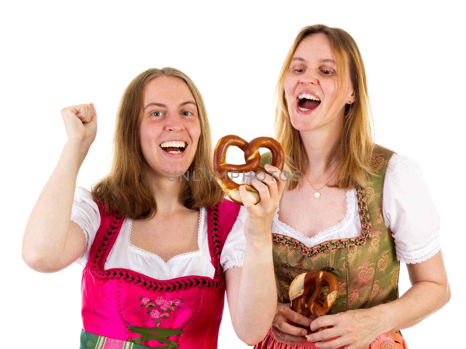 Women in dirndl eating delicious pretzel by gwolters