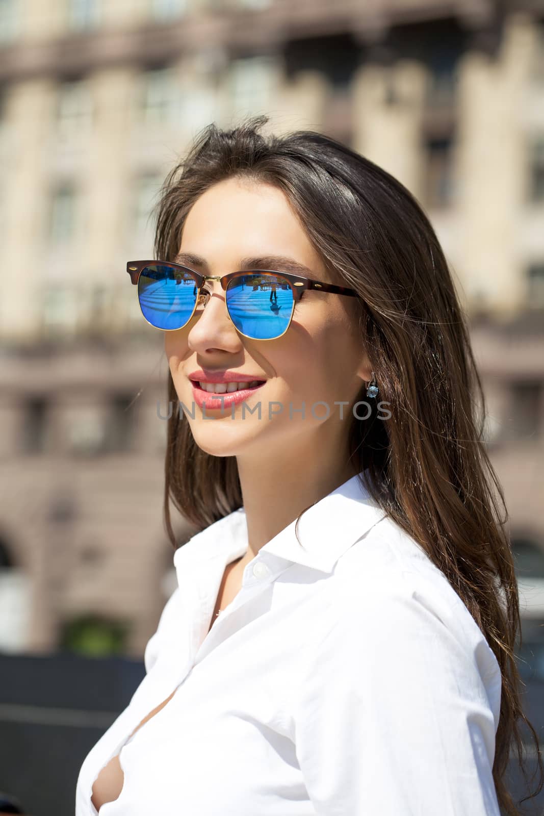 Business woman with blue mirrored sunglasses by andersonrise