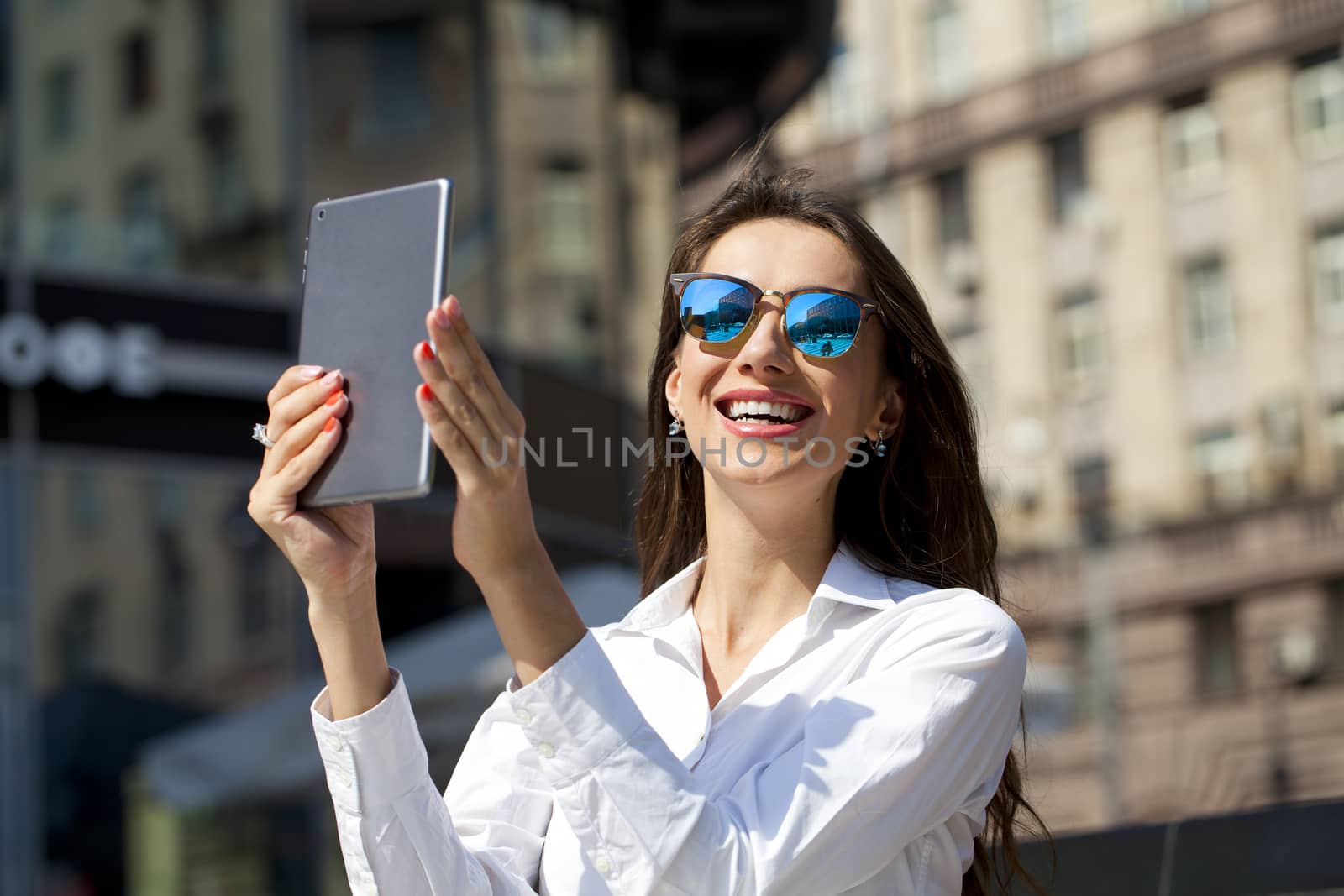 Beautiful business woman reading notepad by andersonrise