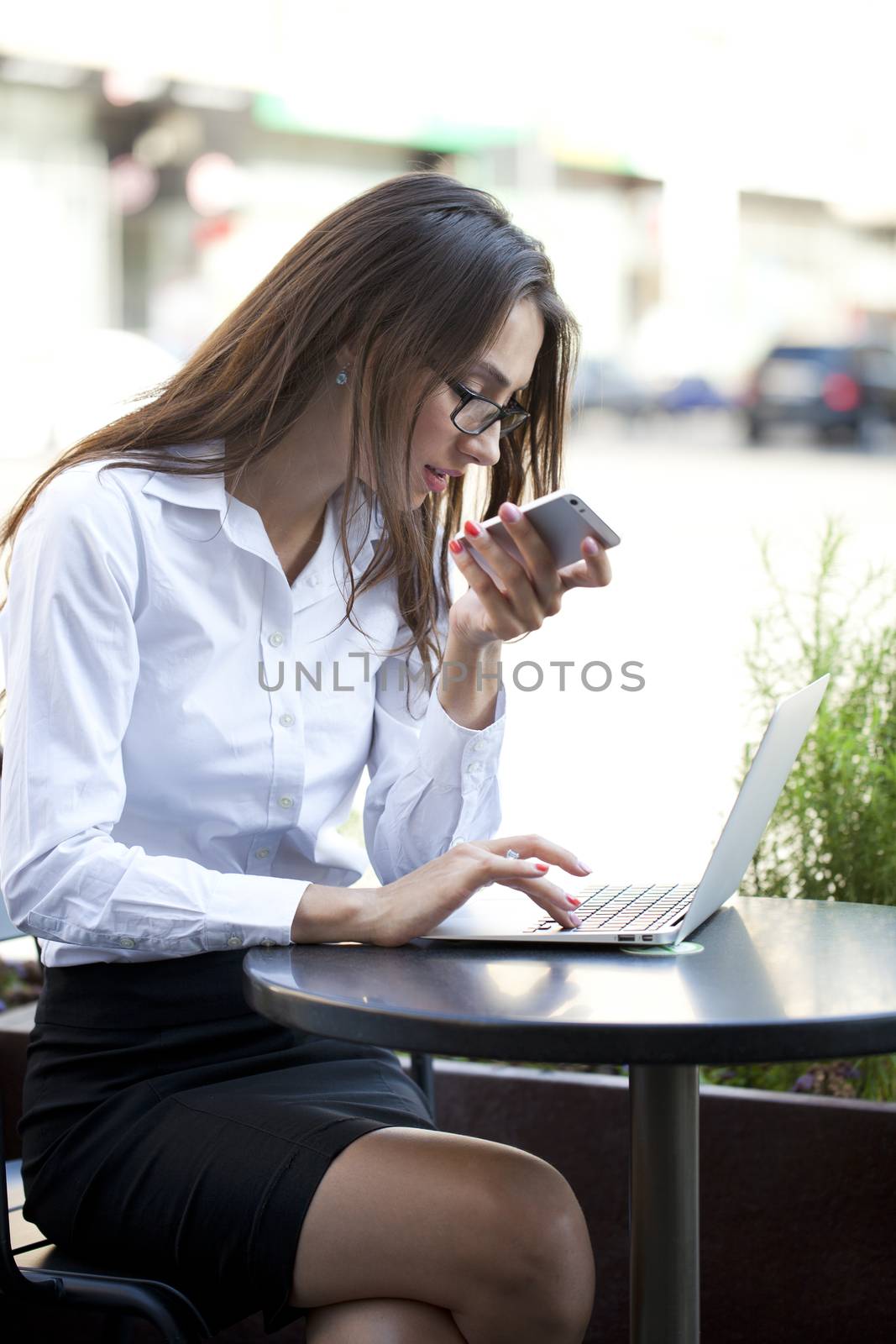 Portrait of young businesswoman working on a laptop