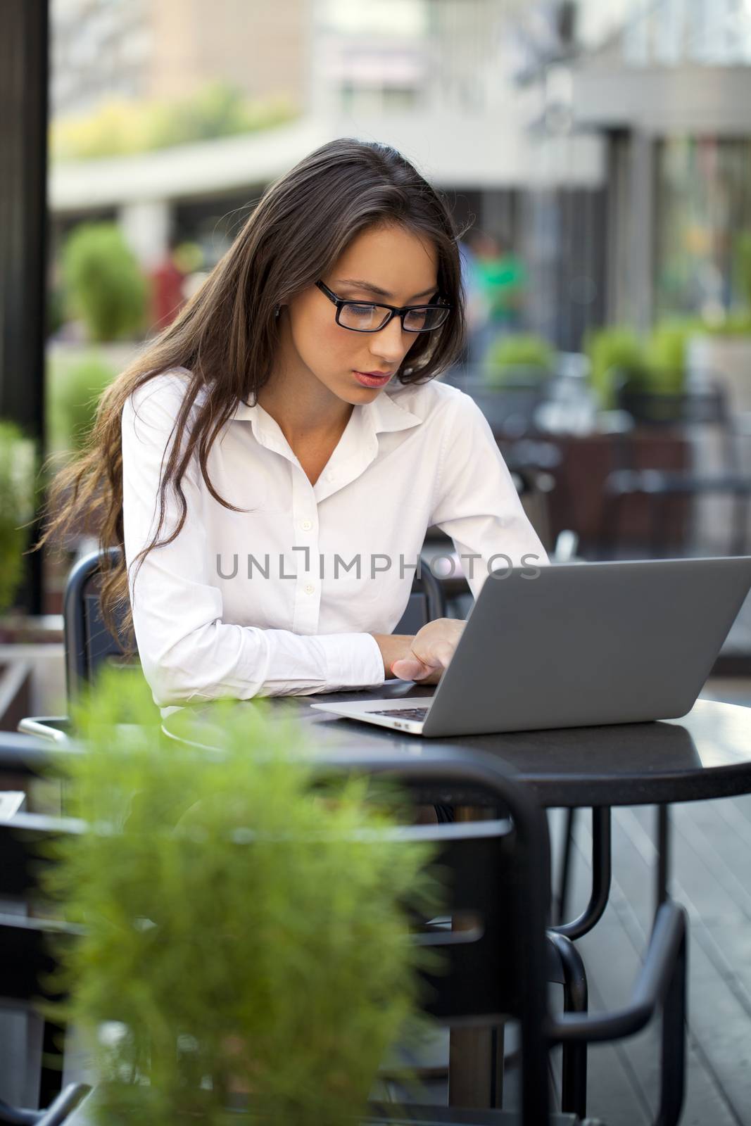 Portrait of young businesswoman working on a laptop