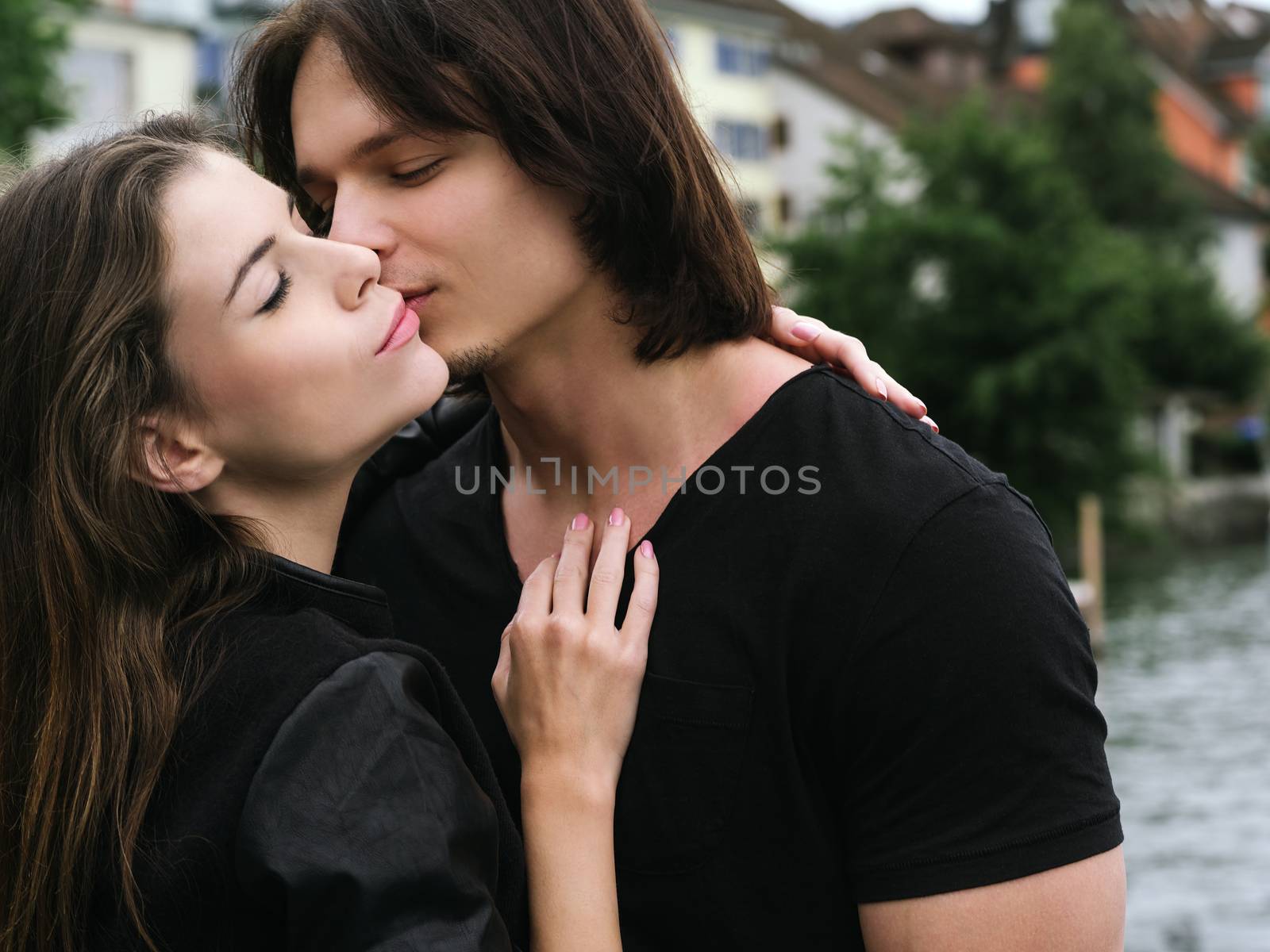 Young couple kissing by sumners