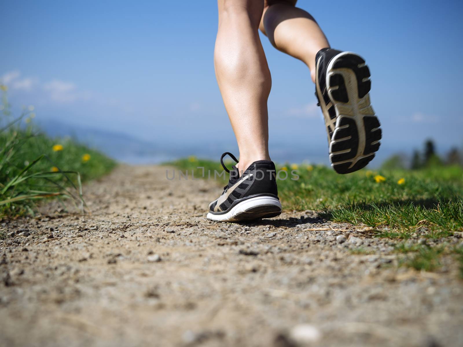 Legs of a woman jogger in the country by sumners