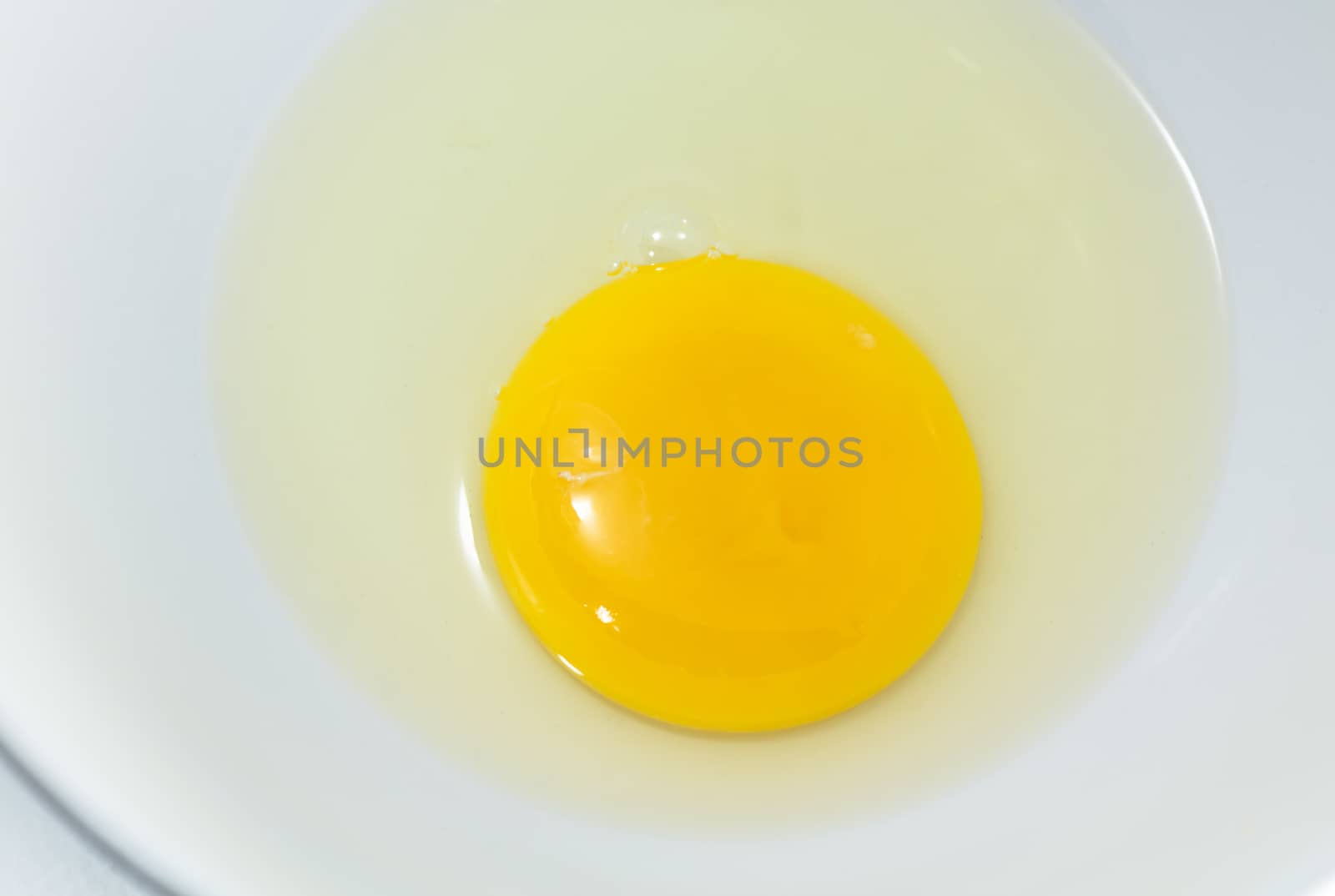 Egg yolk closeup on white background