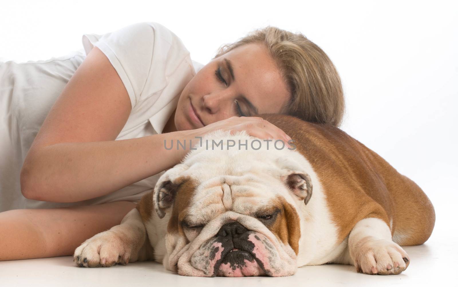 woman resting her head on her english bulldog on white background