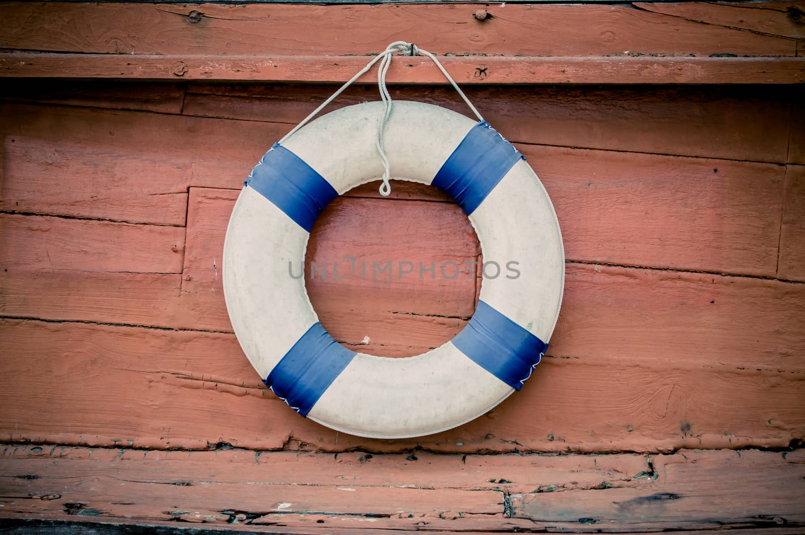 lifebuoy blue stripes. attached to side of the ship. readily available.
