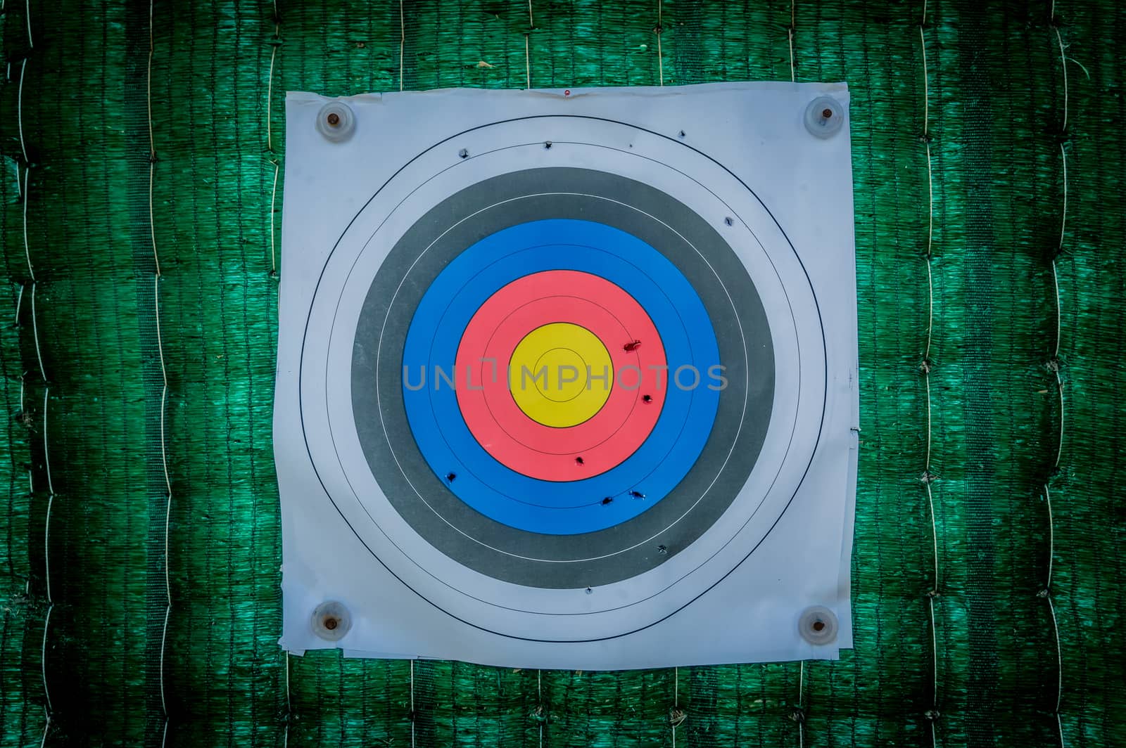 Close up of a shooting target and bullseye with bullet holes