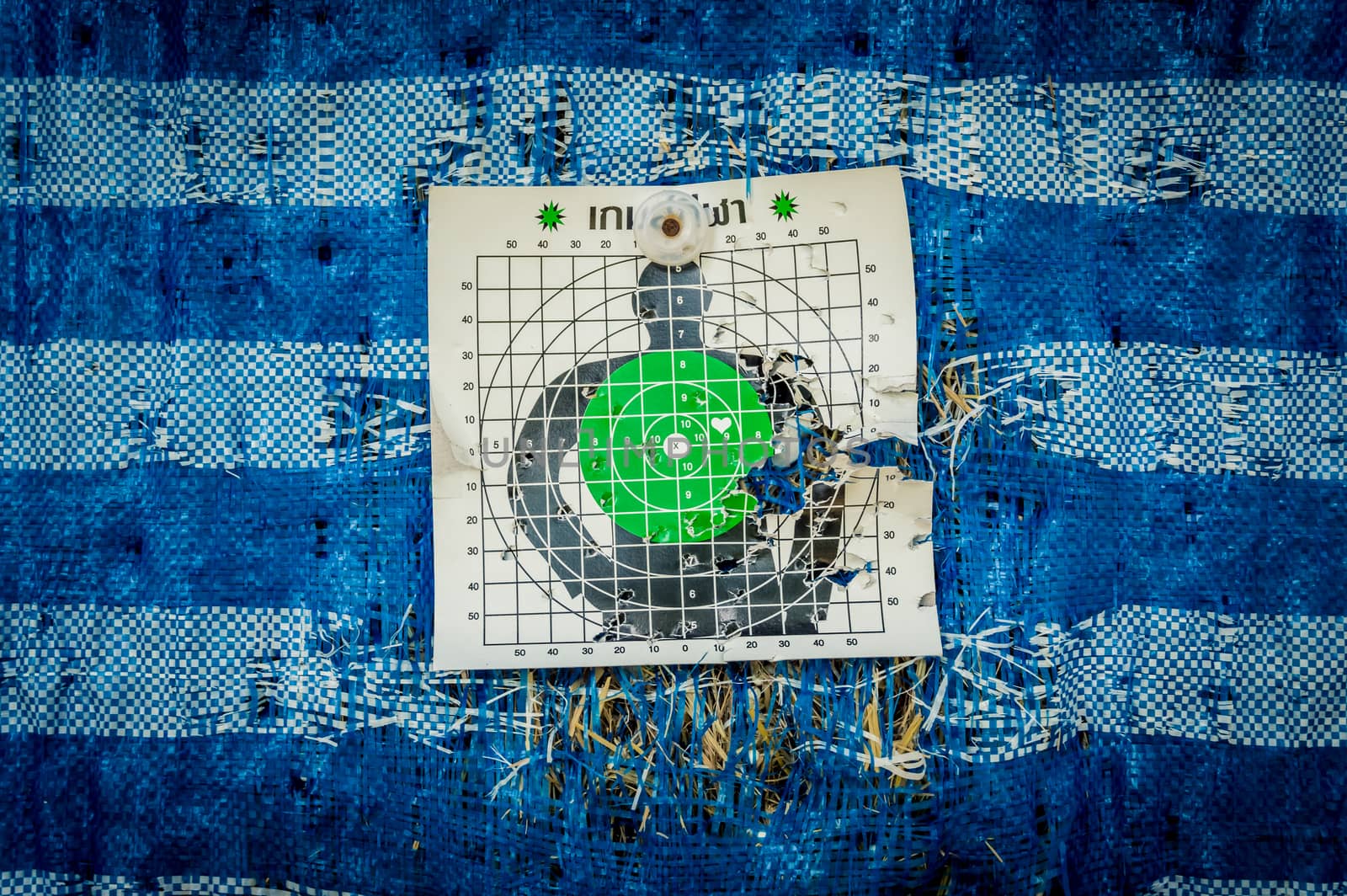 Close up of a shooting target and bullseye with bullet holes