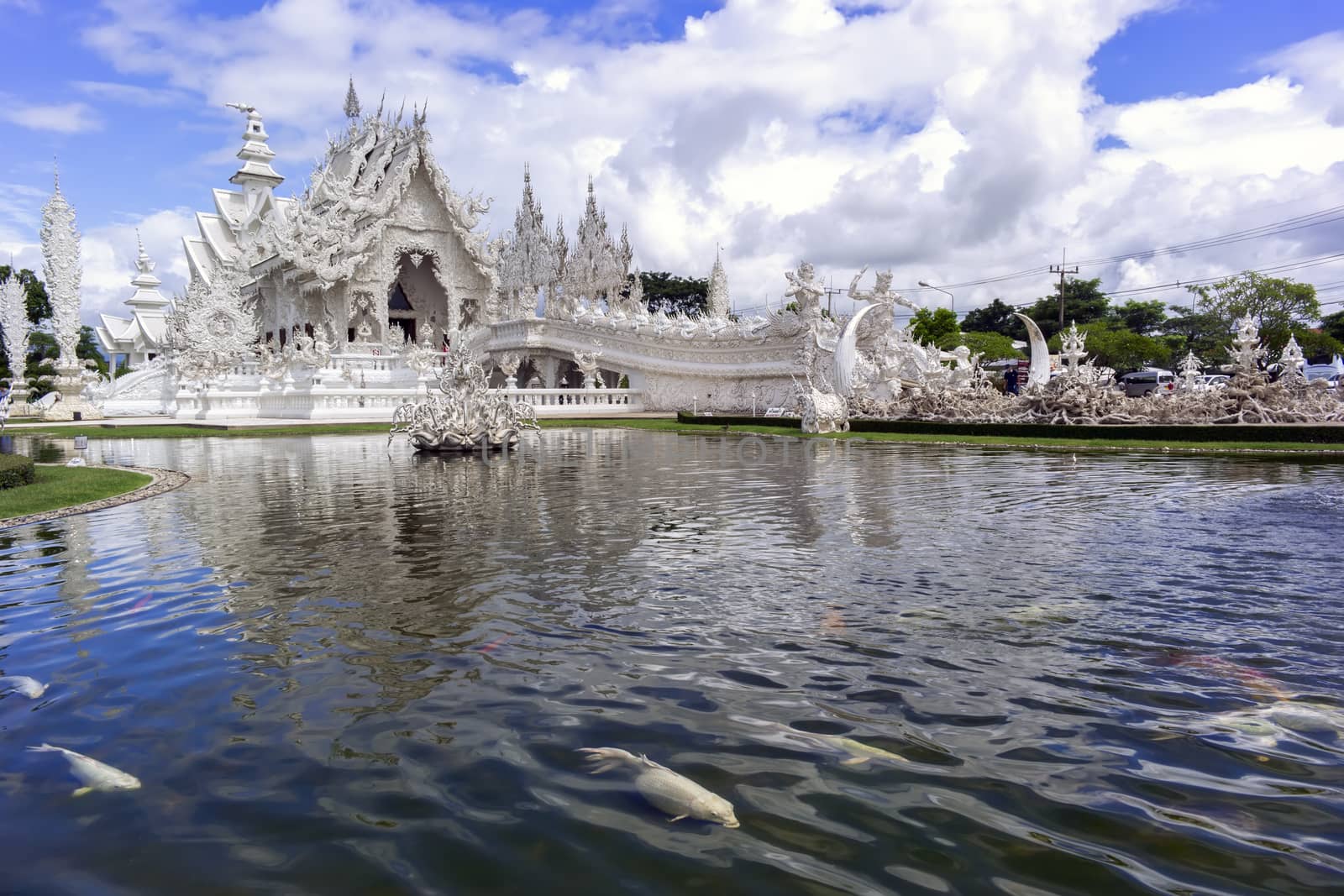 White Temple and Fish. Contemporary unconventional Buddhist temple in Chiang Rai, Thailand.