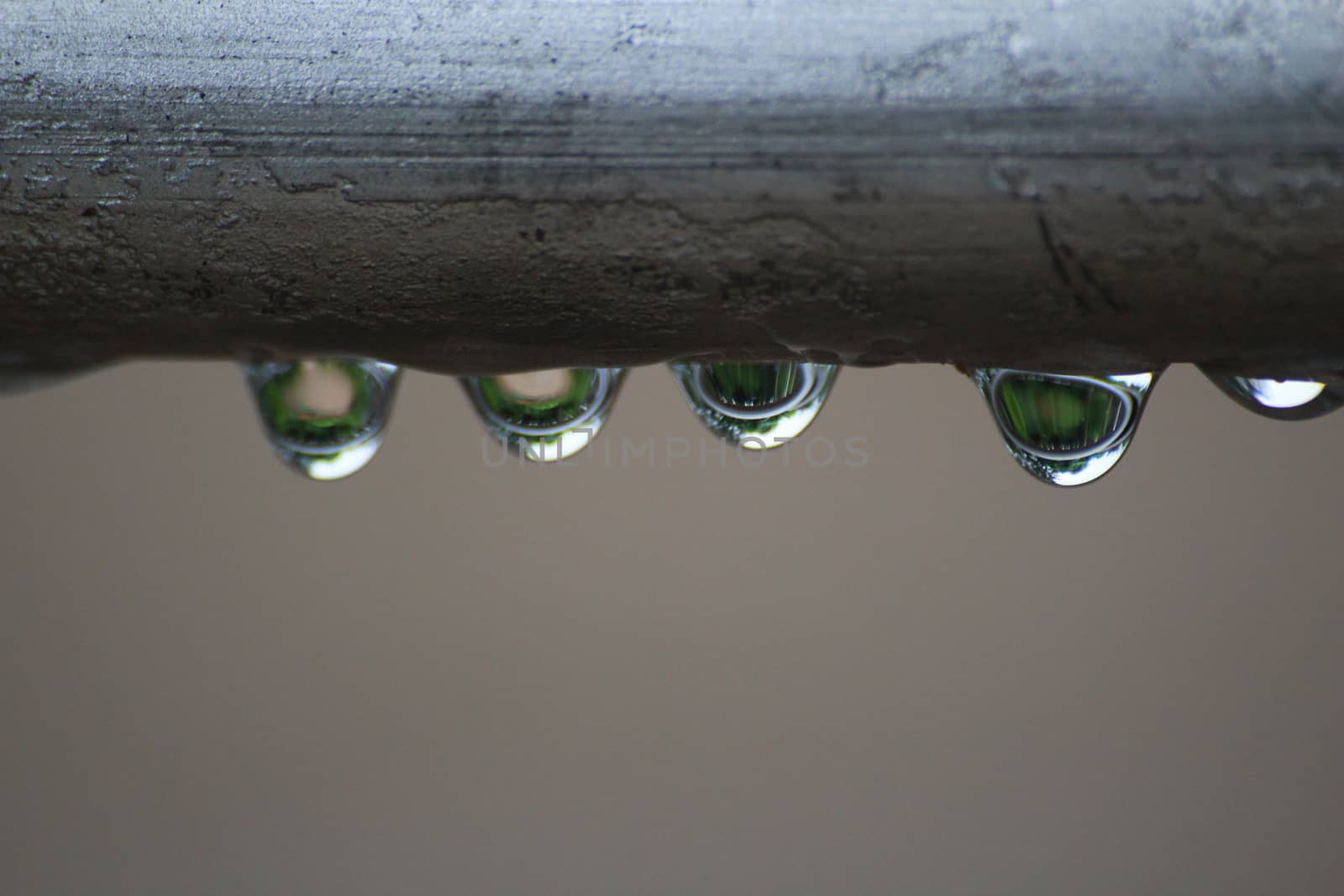 The drops from surface of steel pipe in raining day.