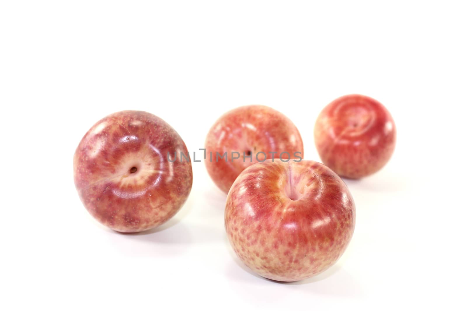 fresh delicious orange-red pluots on a light background
