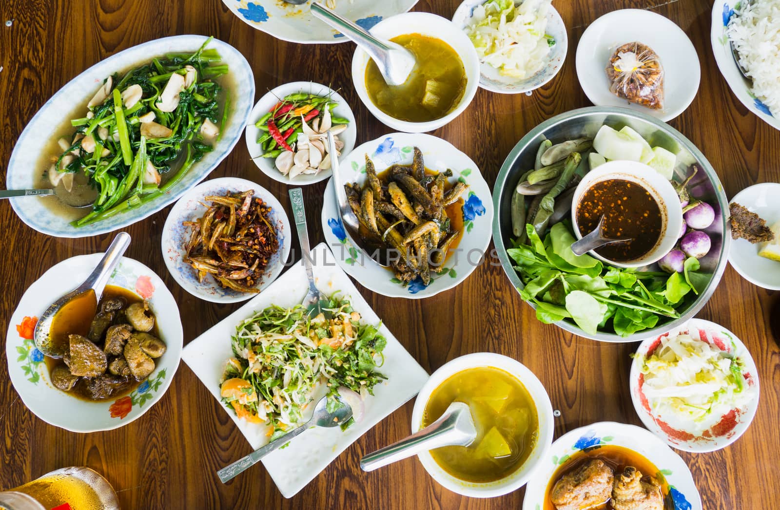 A table with assorted food at a restaurant in Myanmar.