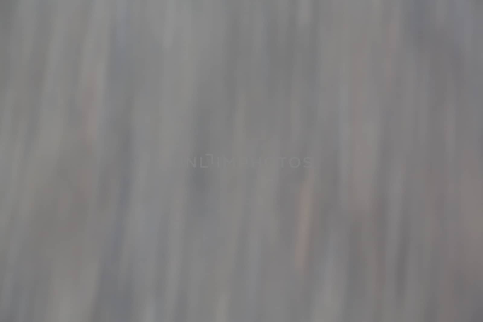 Defocused and slight element on motion blur on grey and hint of color background that has dreamy dreamlike calm feeling