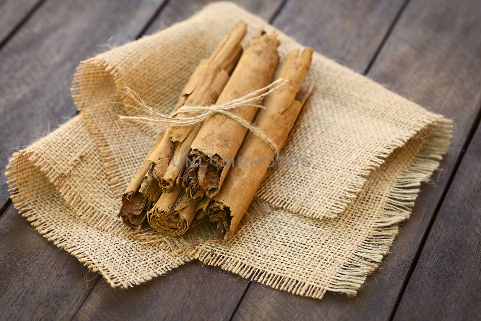 Cinnamon sticks on jute fabric (Selective Focus, Focus on the front of the upper sticks) 