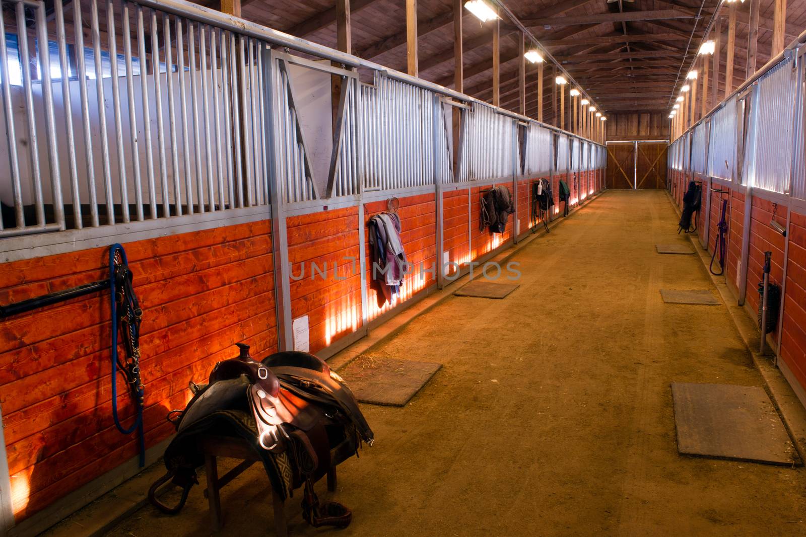 A saddle waits to be mounted on horses back at stables