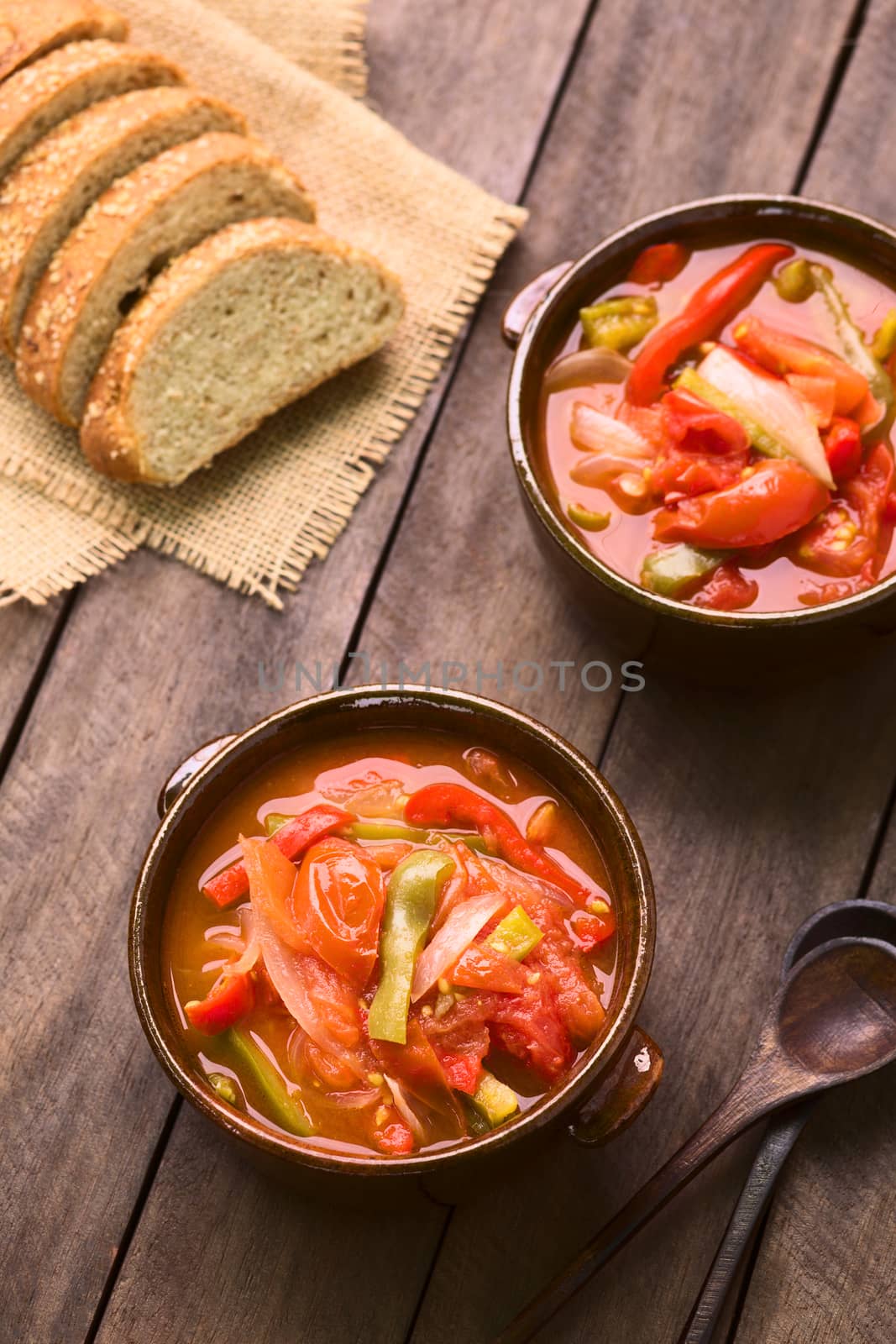 Two bowls of Hungarian traditional dish called Lecso, a vegetarian stew made of onion, pepper and tomato, seasoned with salt and pepper. It can be accompanied by bread or rice (Selective Focus, Focus in the middle of the first dish)  